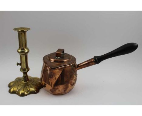 A 19th century brass candlestick, with extractor mechanism, on petal base, 28.5cm high, together with a George III copper pou