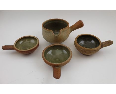 A 20th century "Leach" pottery stoneware bowl with pouring lip and side handle, together with five single handled small bowls