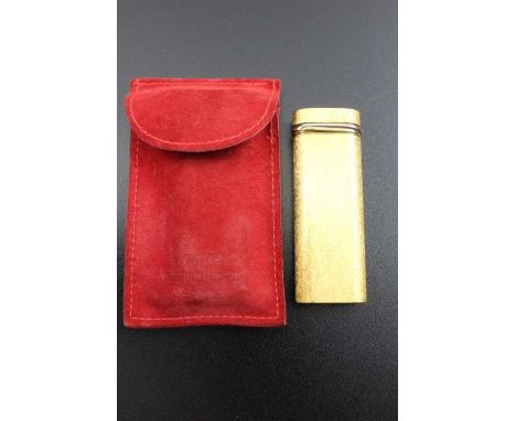 A Cartier of Paris gold plated lighter, brushed matt finish, No. 144091, in an original red suede Cartier pouch