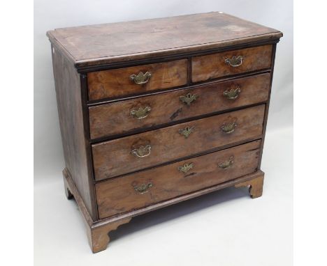 An 18th century yew wood chest of drawers, two short over three long, with brass handles on bracket feet, 94cm wide