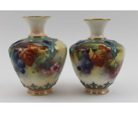 Two Worcester porcelain vases, (very much a pair) both with moulded Hadley strapwork and painted with brambles, 10cm high, on