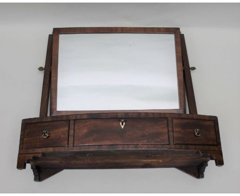 A 19th century mahogany dressing table mirror with adjustable plain plate, the bow front box base fitted three drawers raised