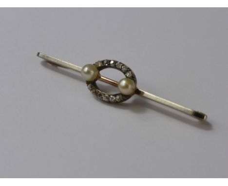 A Yellow and White Gold Diamond and Pearl Stick Pin, the pin set with six old cut diamonds in a crescent form above and below