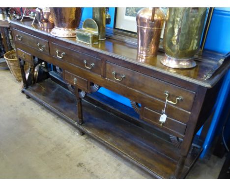 An Antique Oak Dresser Base, three drawers to top, three drawers to bottom, the dresser base on turned supports with shelf be