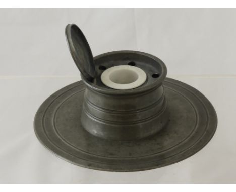 An Antique Pewter Ink Well with the original porcelain liner, a hammered pewter lamp base depicting garden birds together wit