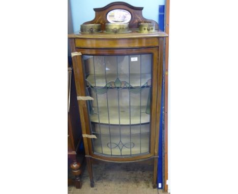 An Edwardian Mahogany Inlaid Bow Fronted Display Cabinet having a stained leaded glass door and two shelves, approx 61 x 35 x