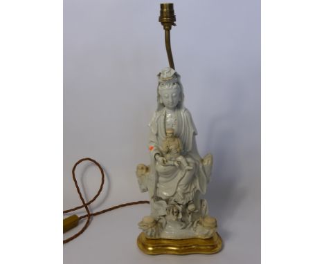 An Antique Blanc de Chine Table Lamp Base, in the form of Guanyin with a smaller figure in her lap, approx 37 cms