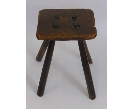 An Antique Oak Milking Stool, on four straight legs.