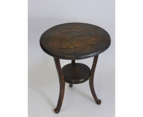 An Antique Oak Occasional Table, on tripod base with the top hand carved with butterflies.