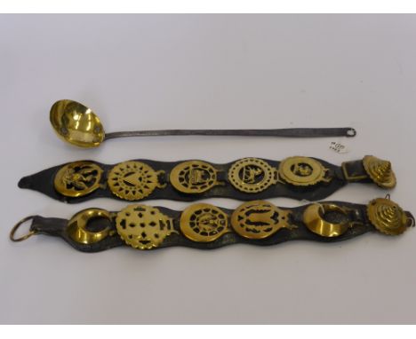 Two Leather Horse Harnesses with five horse brasses to each together with a brass and wrought iron fireside ladle. (2)