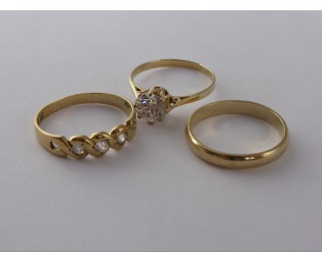 Three 9 ct Gold Rings, including wedding band, solitaire C.Z and a white stone ring size L/M.