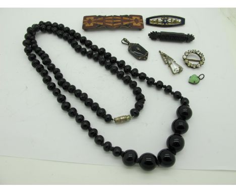 A Victorian Style Jet Coloured Bar Brooch, of textured design, a similar Marcasite pendant, a singe strand of graduated beads