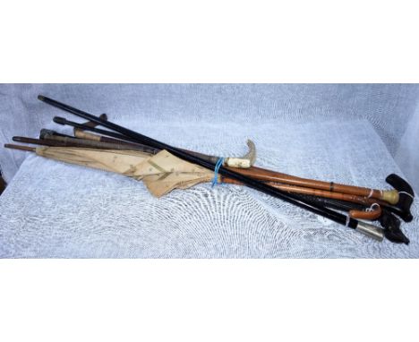 A TANK REGIMENT SWAGGER STICK ('FEAR NAUGHT'), AN EDWARDIAN PARASOL, AN EBONY STICK WITH DOG'S HEAD CARVED HANDLE, and other 