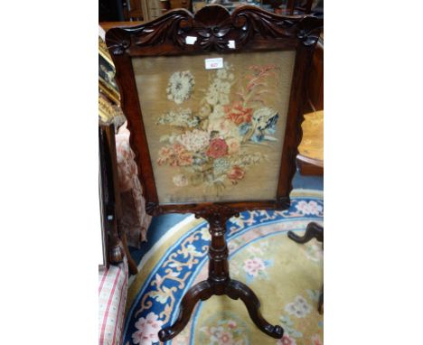 A VICTORIAN ROSEWOOD POLE FIRE SCREEN with foliate needlework panel, 44cm wide 