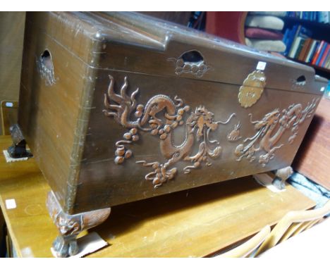 AN ORIENTAL CARVED CAMPHOR WOOD TRUNK decorated with dragons, 102cm wide 