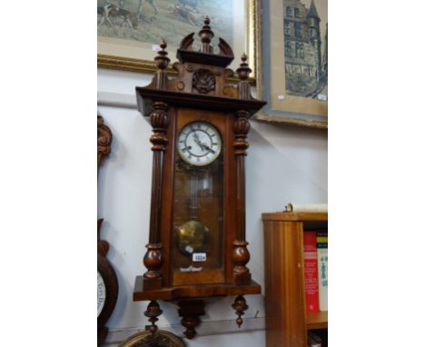 A LATE VICTORIAN WALNUT CASED WALL CLOCK, 96cm high (working and striking)
