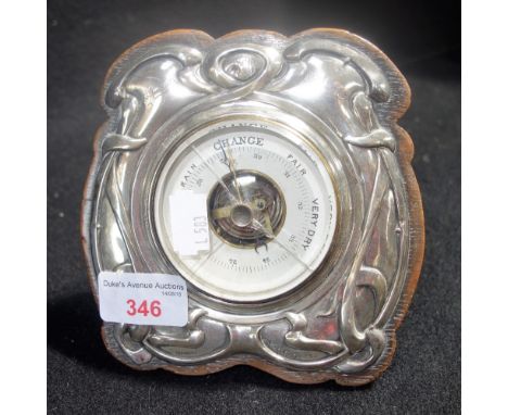 AN ART NOUVEAU SILVER AND WOODEN DESK BAROMETER, with easel stand, by M & Co presented in 1908 