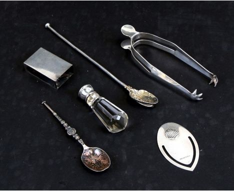 An Asprey silver matchbox cover, London 1938; together with a pair of silver sugar tongs, London 1908; a crystal desk seal wi
