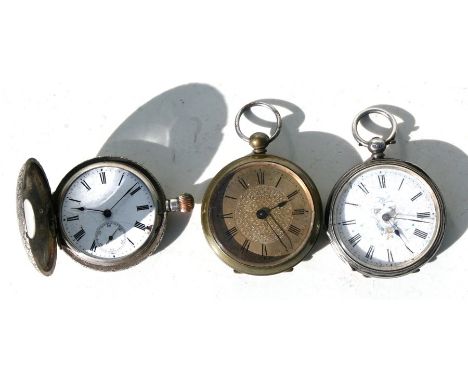 A silver half hunter pocket watch with pink enamel chapter ring; together with another silver fob watch and a similar brass e