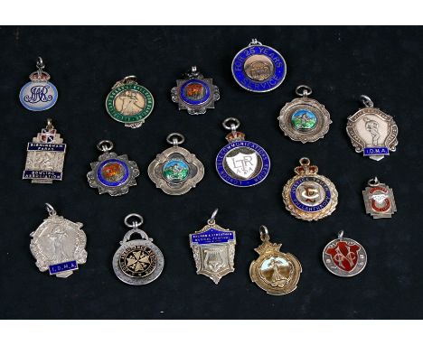Eighteen silver and enamel fobs with various dates and makers marks.