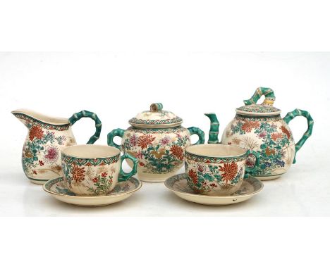 A Japanese Satsuma part tea service comprising a teapot and cover, sugar bowl and cover, milk jug, two cups and two saucers.