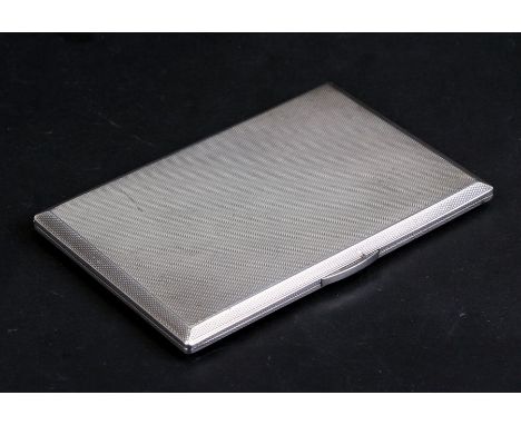 A silver cigarette case with engine turned decoration, London 1946, weight 196g, 12cms (4.75ins) wide.