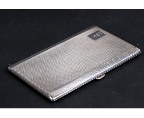 A silver cigarette case with engine turned decoration and initialled, Birmingham 1952, weight 209g, 14cms (5.5ins) wide.
