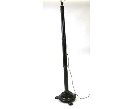 A late Victorian mahogany standard lamp with reeded column and circular stepped base on lions paw feet, 163cms (64ins) high.