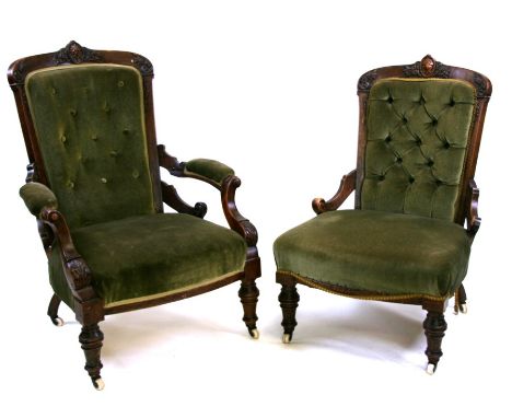 A Victorian ladies and gentleman's pair of walnut upholstered button backed parlour chairs with acanthus leaf details on turn