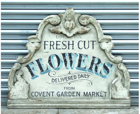 An antique style painted wall plaque 'Fresh Cut Flowers Delivered Daily from the Covent Garden Market', 89cms (35ins) wide.