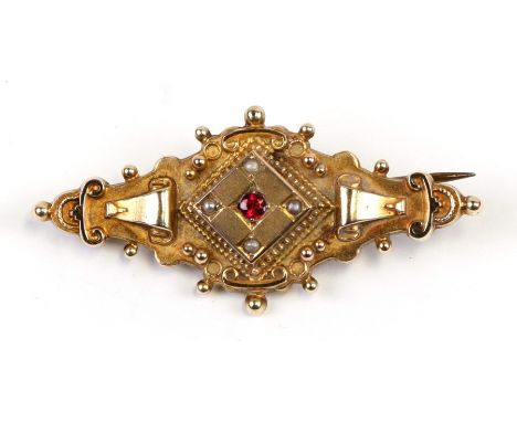 A Victorian 9ct gold ruby and seed pearl set mourning brooch, 5cms (2ins) wide.