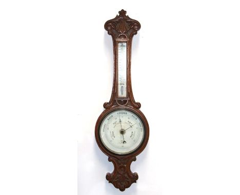 An Edwardian barometer thermometer in a carved oak case, 84cms (33ins) high.Condition ReportGlass diameter 20cm, four screws 