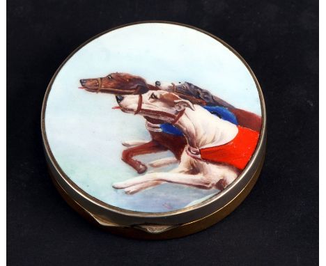 A circular metal snuff or pill box, the lid enamelled with racing greyhounds, opening to reveal a gilded interior, 5.5cms (2 