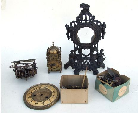 A Smiths 8-day brass lantern clock; together with a quantity of clock spares.