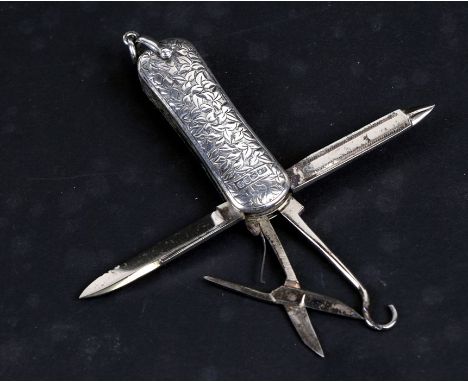 A late Victorian silver coloured metal chatelaine or fob etui with fold-out knife and tools, makers mark and inscription date