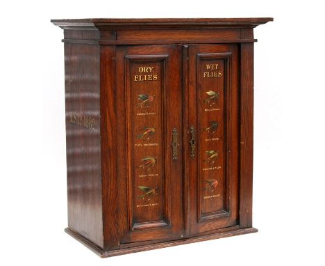 Sporting interest.  An oak wall mounted two-door cupboard, later painted 'Dry Flies &amp; Wet Flies', 62cms (24.5ins) wide. 7