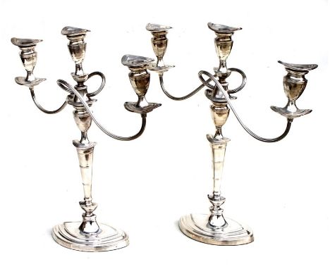 A pair of George III style silver plated three-arm candelabra with detachable sconces, 42cms (16.5ins) high.
