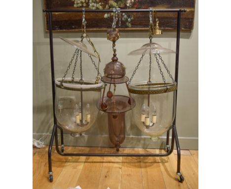 20th Century.&nbsp;Two similar George III style inverted bell-shaped glass hall lanterns. Each with dish-shaped glass smoke s