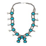 Native American, Circa 1970, A silver and turquoise bead squash blossom necklace