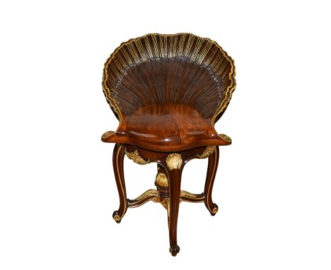 French, Circa 1890s A hardwood parcel gilt piano stool with an oversized shell motif swivel seat, with four legs and a centra