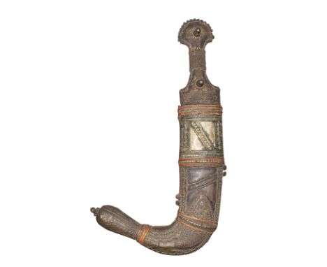 20th century Yemeni (?)  A jambiya, with an ornate accompanying sheath. The hilt and sheath are heavily worked and decorated 