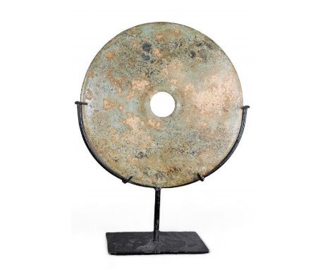 Chinese A mottled jade disk on metal stand  Dimensions: (Disk) 12 in. (D) (Incl. stand) 16.5 in. (H) x 12 in. (W) x 3.4 in. (