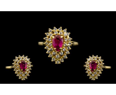 18ct Gold - Nice Quality Ruby and Diamond Set Cluster Ring. The Central Pear Shaped Ruby of Excellent Colour. Surrounded by 3