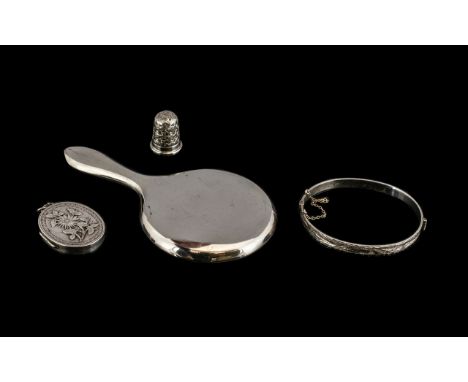 Collection Of Silver. Collection of silver to include small hand mirror, bangle with safety chain, thimble and locket, all pi