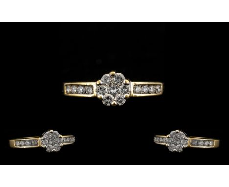 18 Carat Gold Attractive and Diamond Set Ladies Cluster Ring. Marked 750. 18ct to interior of shank. The brilliant cut diamon
