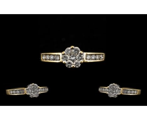 18 Carat Gold Attractive and Diamond Set Ladies Cluster Ring. Marked 750. 18ct to interior of shank. The brilliant cut diamon