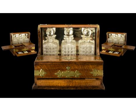 Fine Quality Oak Cased Antique Tantalus Compendium with mirror back and brass carrying handles fitted with three fine quality