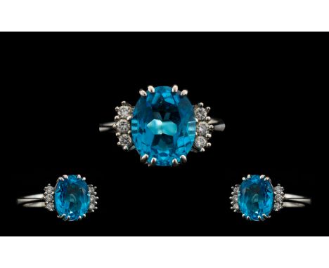 18ct White Gold - Superb Quality and Attractive Blue Topaz and Diamond Set Dress Ring. The Oval Faceted Blue Topaz of Excelle