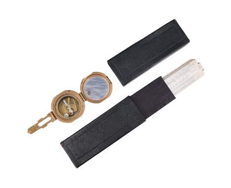 A P.I.C. slide rule together with a brass magnetic compass