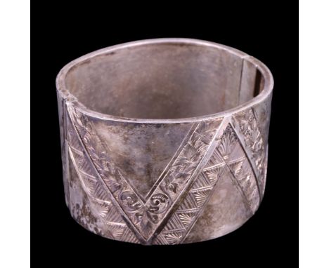 A Victorian silver cuff bangle, decorated with engraved geometric and floral chevron bands, 38 mm x 59 mm x 56 mm, 49 g